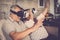 Senior people couple enjoying at home the new goggled headset technology with glasses and virtual reality - stay at home and have