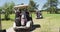 Senior people driving a golf cart with clubs on the back at golf course