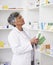 Senior pharmacist woman, shelf and boxes with thinking, packing stock and inventory inspection. Mature pharmacy manager