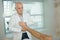 Senior physiotherapist giving foot massage to woman in clinic