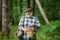 Senior picking wild berries and mushrooms in national park forest. Mushroom picker. Grandfather.