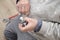 Senior plumber hands putting teflon thread tape on the faucet.