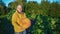 Senior positive man with smile holds big orange pumpkin in hands