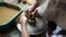 Senior potter teaching happy little girl the art of pottery