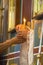 Senior priest hands giving candles to an old lady