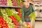Senior puts fresh vegetables in shopping cart
