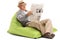 Senior reading newspaper seated on beanbag