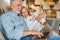 Senior retired couple with dog on sofa