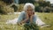 Senior retired woman enjoying the sunny autumn day in the park