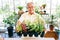 Senior retirement gardener man holding organic seedlings and plants on his hand with smiles and happiness in indoor gardening