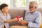 Senior retirement man is happy with his surprise birthday gift from grandson