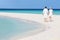 Senior Romantic Couple Walking On Beautiful Tropical Beach