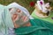 A senior\'s face is covered by clay facial mask.Close up