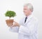 Senior scientist holding plant