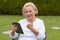 Senior serene woman using a black tablet PC