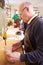 Senior shoemaker shaping shoe lasts in a workshop