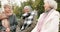 Senior, smile and relax with friends on park bench for retirement, happy and health. Elderly, happiness and social with
