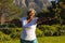 Senior smiling african american woman practicing yoga in stunning countryside