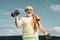 Senior sportman lifting dumbbells. Healthcare cheerful lifestyle. Elderly man workout.