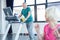 Senior sportsman training on treadmill, senior sportswoman on foreground