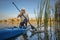 Senior stand up paddler on a lake