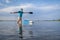 Senior stand up paddler is stretching and warming up