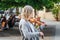 Senior Street musician playing violin at the old city