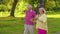 Senior stylish couple family grandmother grandfather dancing, walking listening music in summer park