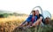 Senior tourist couple in love sitting in nature at sunset, resting.