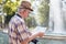 Senior tourist man searching for destination on map