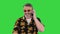 Senior traveler in sunglasses walking and making a call on a Green Screen, Chroma Key.