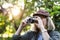 Senior trekker taking a photo with a film camera