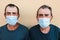 Senior twin men smiling on camera while wearing safety mask during coronavirus outbreak - Focus on faces