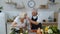 Senior vegan grandmother and grandfather cooking salad with fresh vegetables in kitchen at home