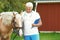 Senior veterinarian with clipboard near palomino horse
