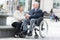 Senior on wheelchair with loving wife next to him