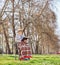 Senior in a wheelchair reading a book in park