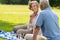 Senior wife and husband playing chess outdoors