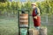 Senior winemaker with press machine on the vineyard