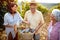 Senior winemakers with daughter in vineyard