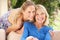 Senior Woman With Adult Daughter Relaxing At Home