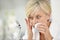 Senior woman applying anti-aging cream on her skin