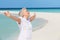 Senior Woman With Arms Outstretched On Beautiful Beach