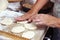 Senior woman baking pies in her home kitchen.Grandma cooks pies. Home cooked food. omemade mold cakes of the dough in the women`s