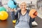 Senior woman balances balls in occupational therapy