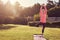 Senior woman in balancing yoga pose with morning sunflare