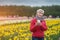 senior woman and beautiful vivid blossoms of flowers on Netherlands tulip fest