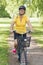 Senior woman bicycling in a park at sunny afternoon