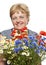 Senior woman with bunch of flowers