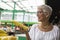 Senior woman buying fresh organic corn on market